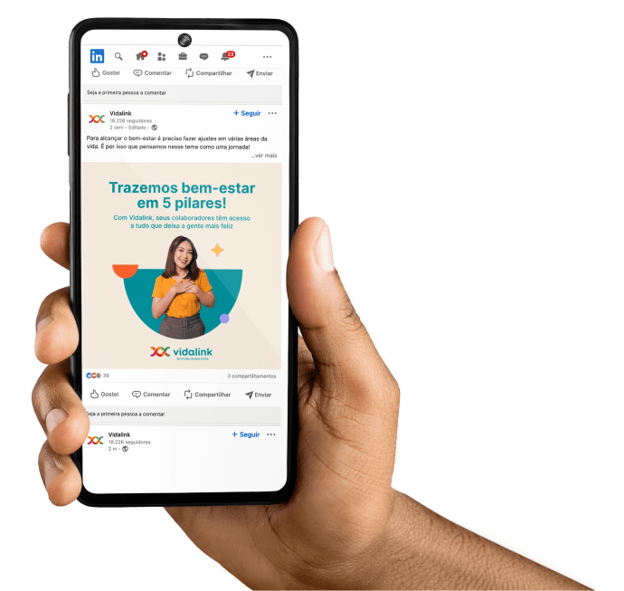 Imagem de uma mão segurando um celular que mostra o perfil da Vidalink no Linkedin